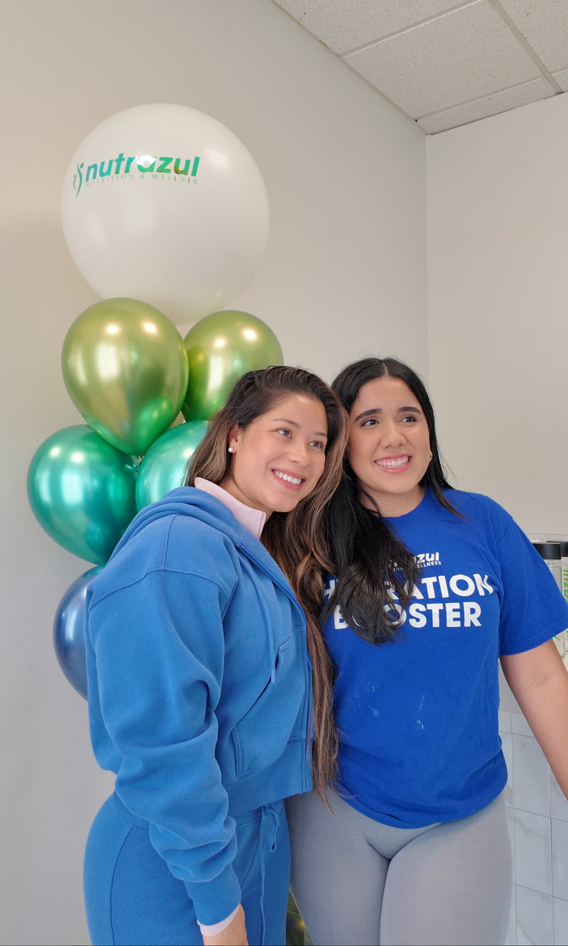 Two women with Nutrazul balloons at the Insoul Pilates studio event